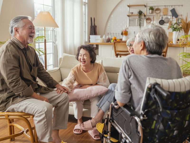 old senior asian friends retired people hapiness positive laugh smile conversation together at living room at nursing home Seniors participating in Group Activities in Adult Daycare Center